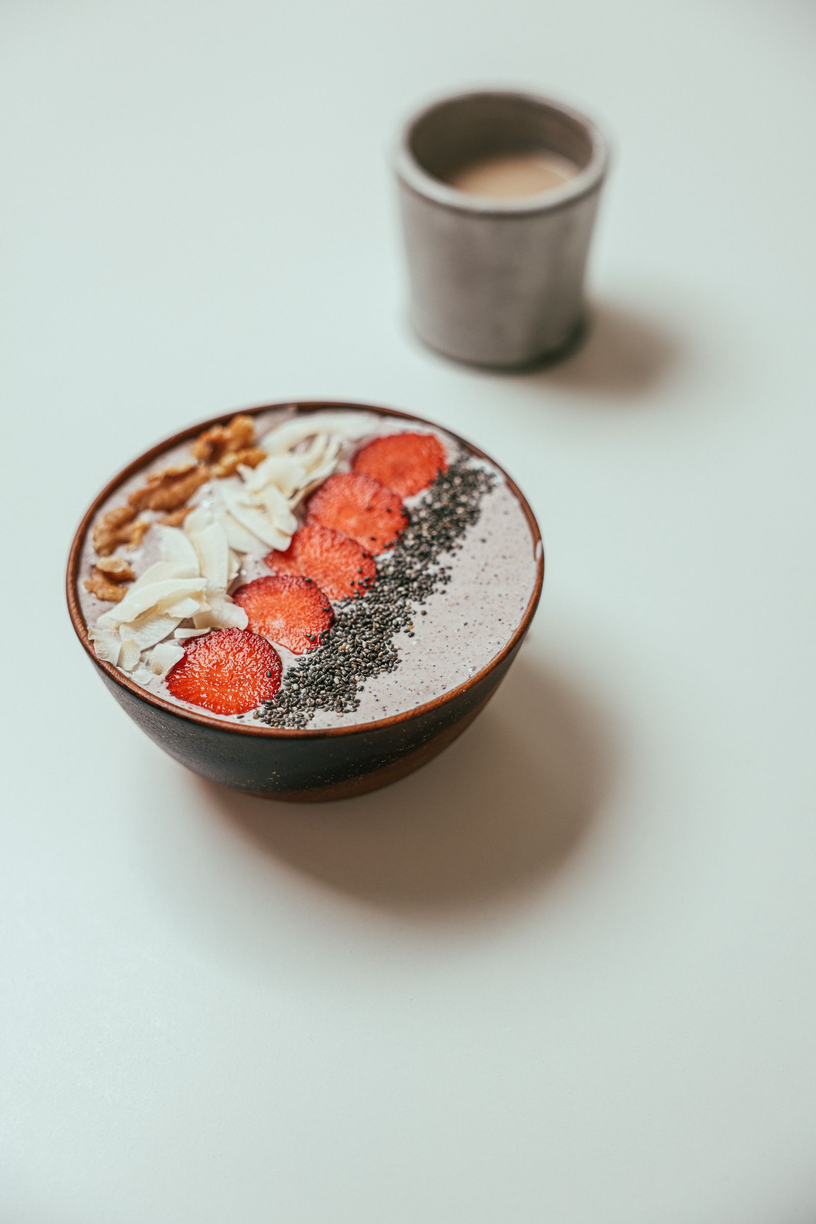 Fruit smoothie bowl topped with granola and berries, representing a blend-it-yourself smoothie format meal delivery