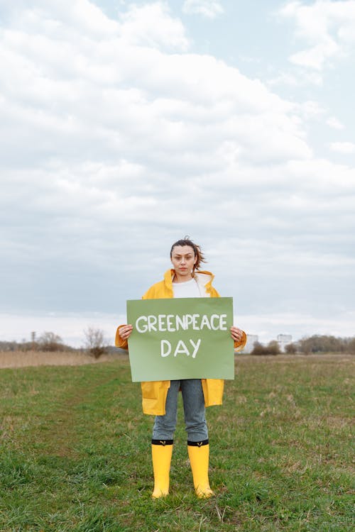 Woman Standing on a Grass Field