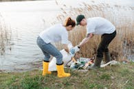 A Man and a Woman Picking Up Garbage