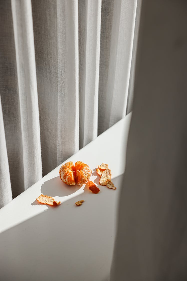 Peeled Orange Fruit On White Table