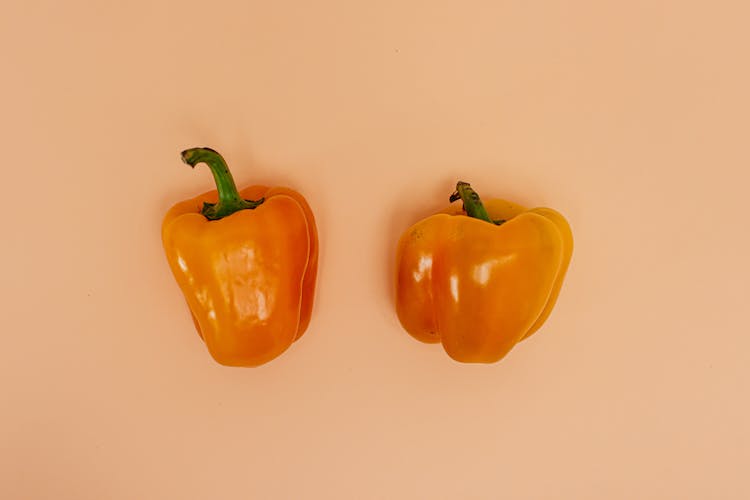 Bell Peppers On Pink Surface