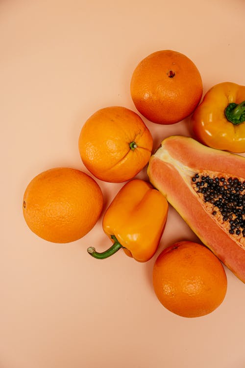 Free Orange Fruits Beside Sliced Papaya Stock Photo