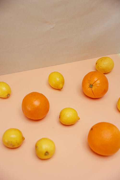 Oranges and Lemons Laid on Pink surface