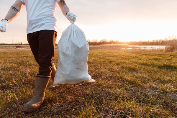 Volunteer carrying a bag of collected litter