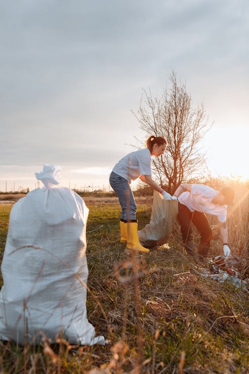Free A Man and a Woman Picking Up Garbage Stock Photo