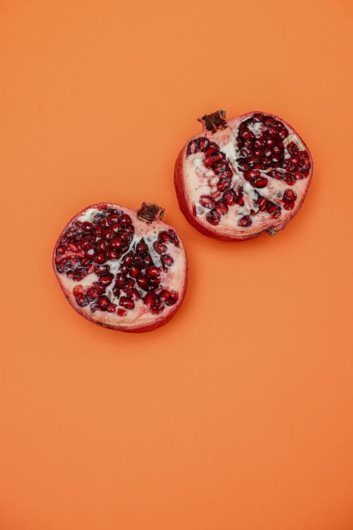 Sliced of Pomegranate on Orange Surface