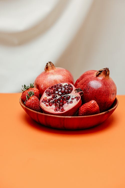 Close Up Photo of Fruits on Wooden Bowl