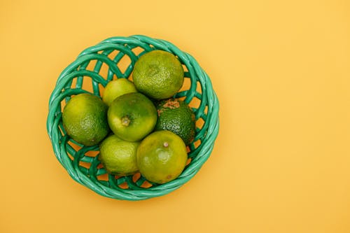 Lime Citrus Fruits in Green Basket