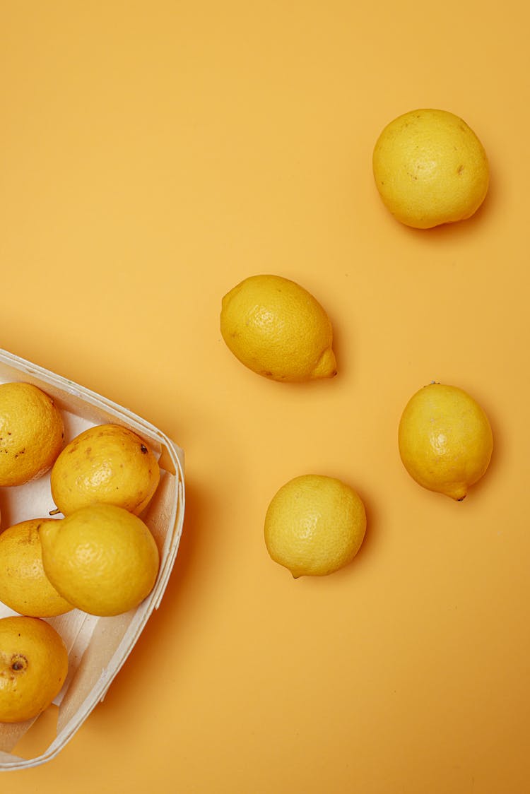 Yellow Lemons On Yellow Surface