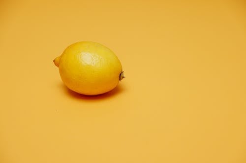 Yellow Lemon Fruit on Yellow Surface