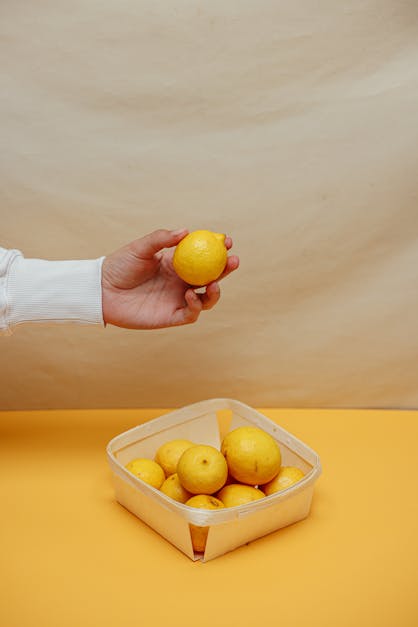 Person Holding Yellow Lemon Fruit · Free Stock Photo