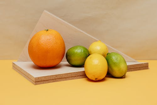Citrus Fruits on Brown Wooden Plank