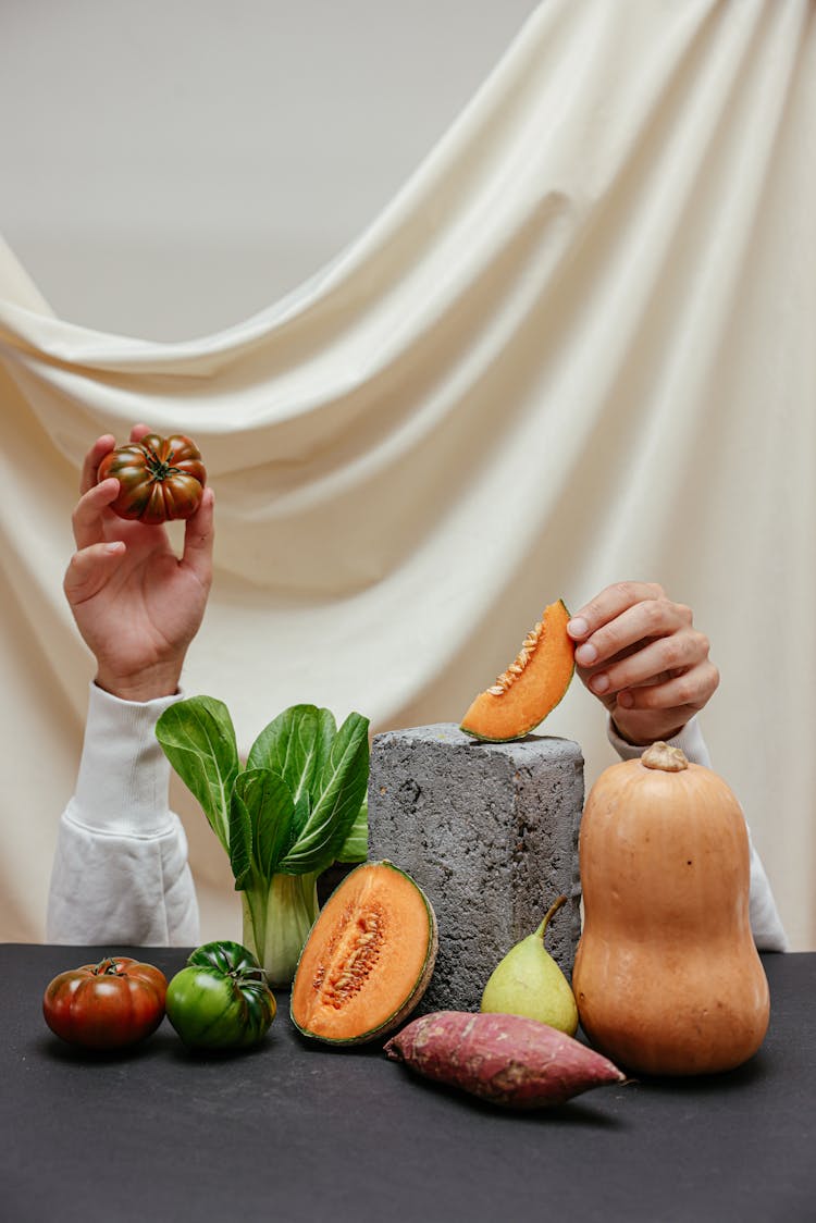 Hands Holding Up Pieces Of Fruits And Vegetables