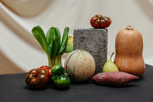 Free A colorful assortment of fresh vegetables and fruits arranged creatively on a table. Stock Photo
