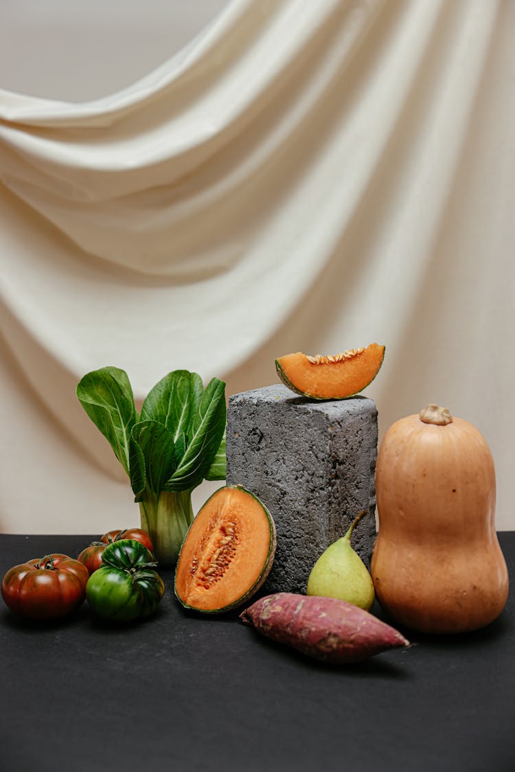 A Display Of Healthy And Delicious Fruits And Vegetables On Black Surface