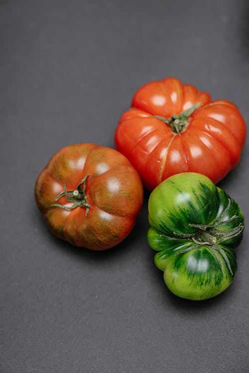 Red and Green Fresh Tomatoes on Gray Surface