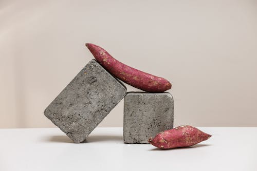 A Pair of Sweet Potatoes on Gray Stones