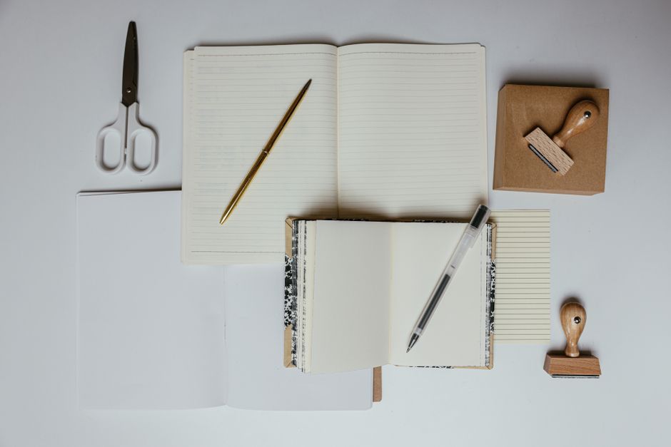 notebook and pen on desk lifestyle photo 2