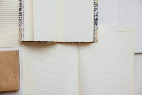 Free A Notebook with Blank Pages Over a Notebook with Lined Pages Stock Photo