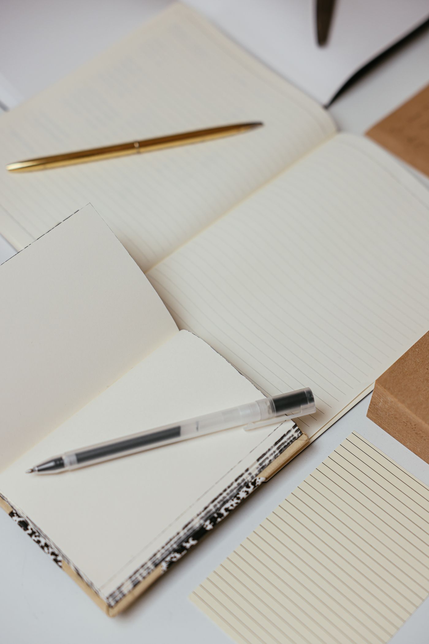 Open notebooks and a pen on a desk