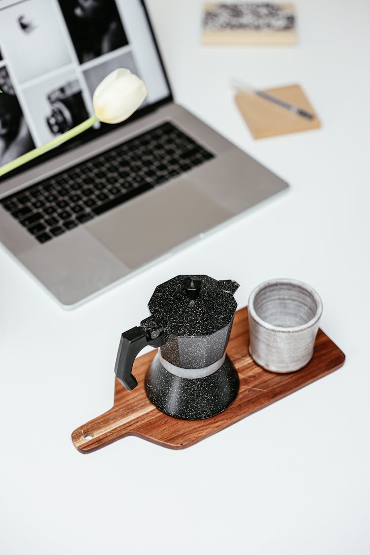 Stovetop Espresso Maker And A Cup On Wooden Tray