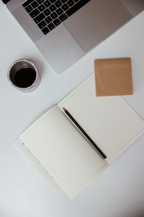 Free A flat lay of a workspace featuring a laptop, notebook, and coffee, ideal for productivity concepts. Stock Photo