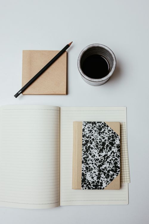 Flat lay of notebooks and pencils on a desk — Cup of Couple on Pexels