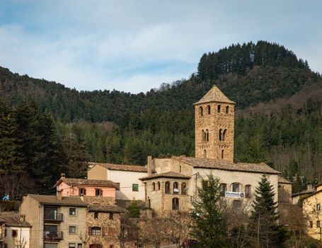 A picturesque mountain village featuring historic stone buildings nestled among lush forests.