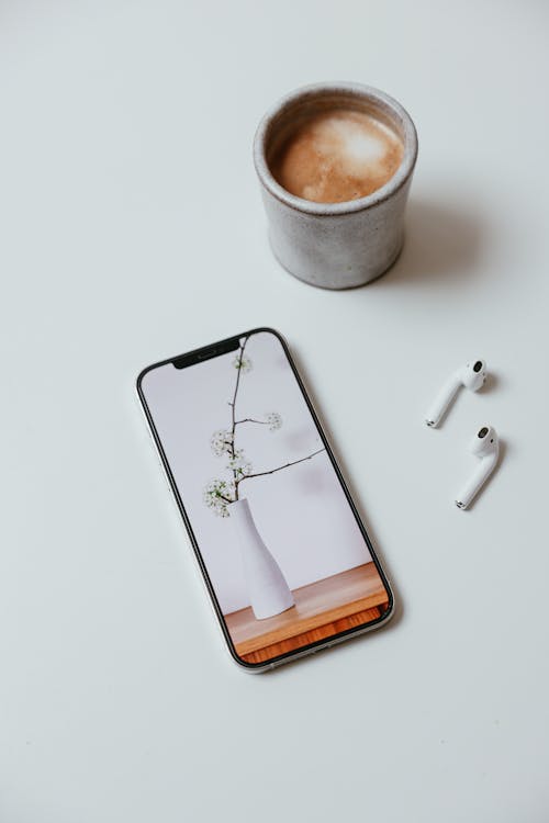 Free A Cup of Coffee Beside the Smartphone Stock Photo