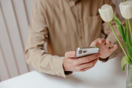 Free Photo of Person Using a Smartphone Stock Photo