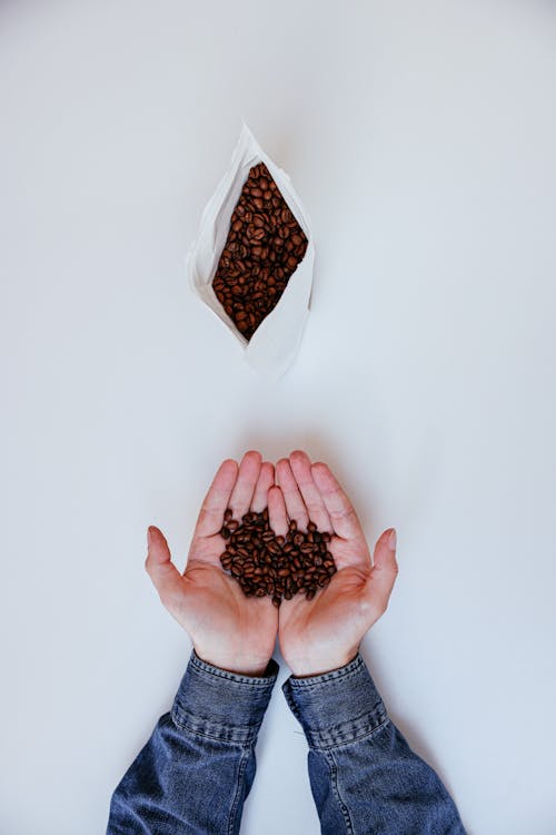 Close-Up Shot of a Person Holding Coffee Beans