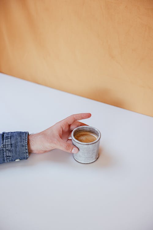 Free Close-Up Shot of a Person Holding a Cup of Coffee Stock Photo