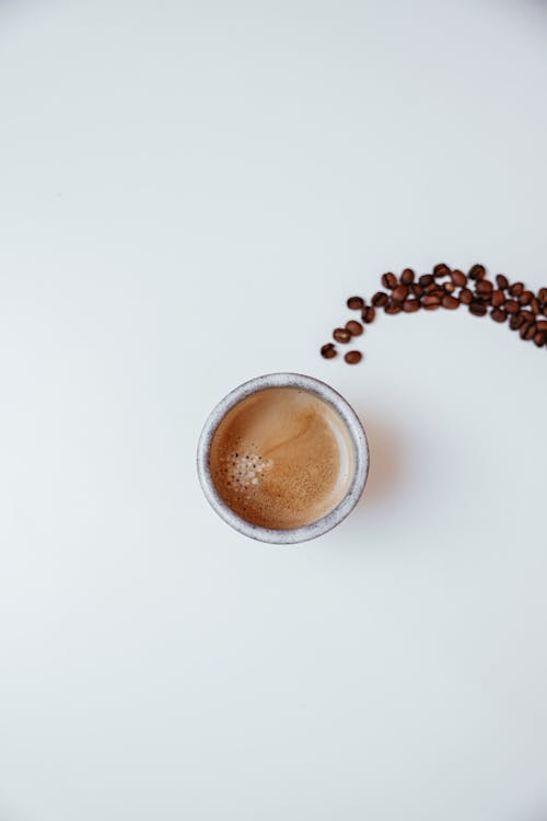 Close-Up Shot of a Cup of Coffee on a White Surface