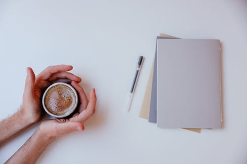 A Person Holding A Cup of Coffee