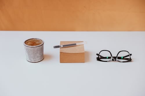 Free A Cup of Coffee, Sticky Note and Eyeglasses on a Table Stock Photo