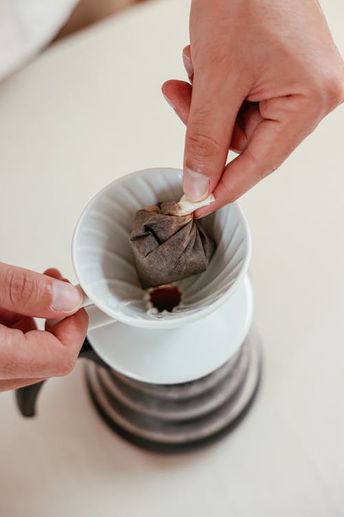 A Close-Up Shot of a Person Making Coffee