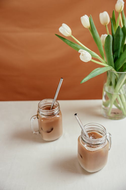 Glasses of Iced Coffee beside a Flower Vase