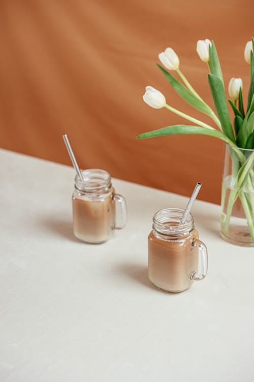 A Pair of Clear Glass Jars of Delicious Iced Coffee