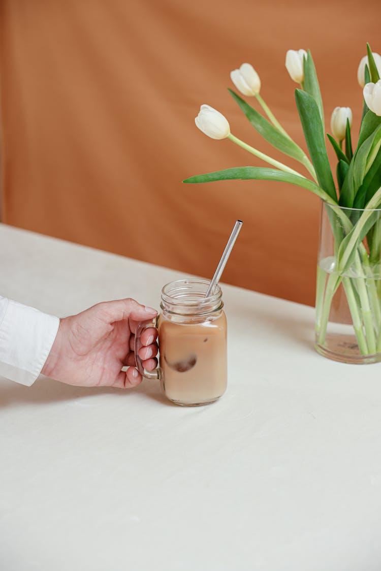 Person Holding An Iced Coffee