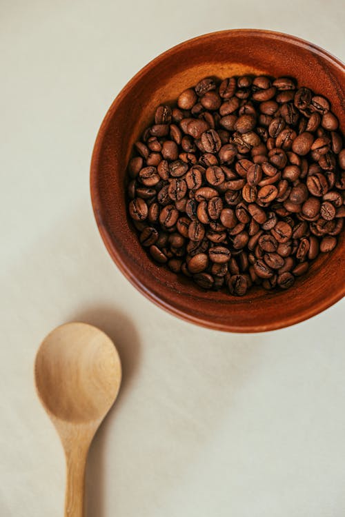 Free Brown Coffee Beans on Brown Wooden Round Bowl Stock Photo