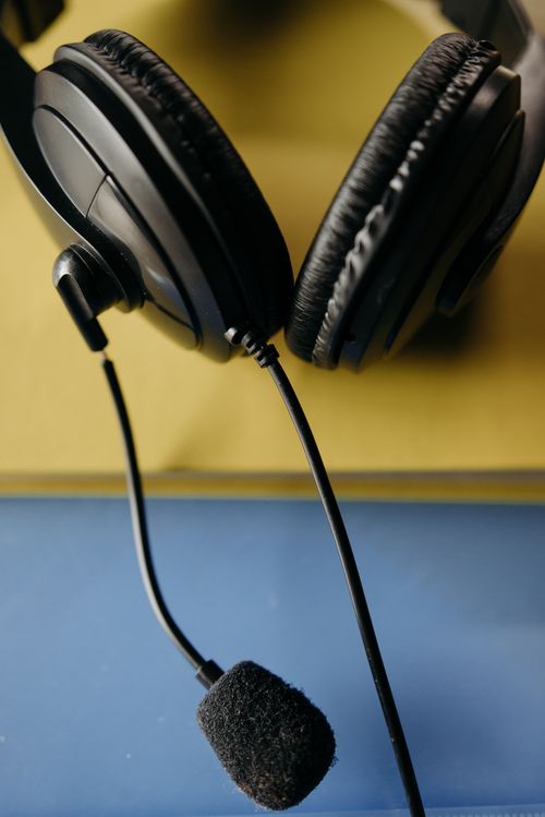Free High-quality close-up of a black headset with microphone on colorful background. Stock Photo