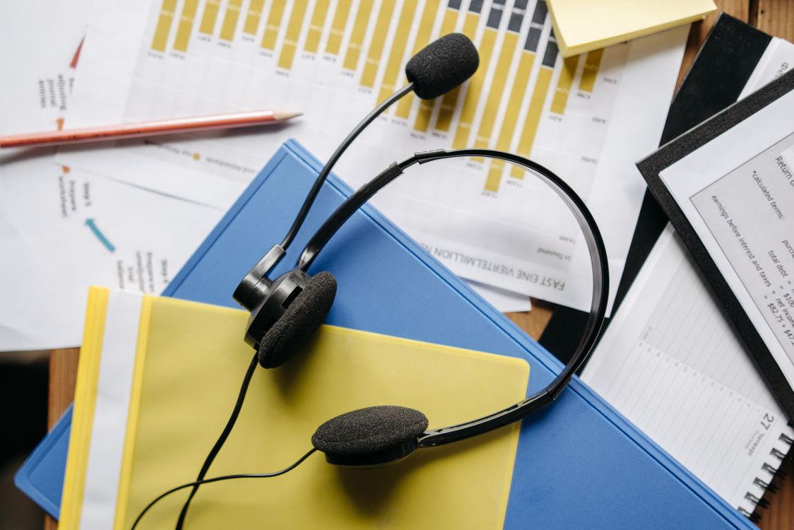 office desk with headset charts and business documents