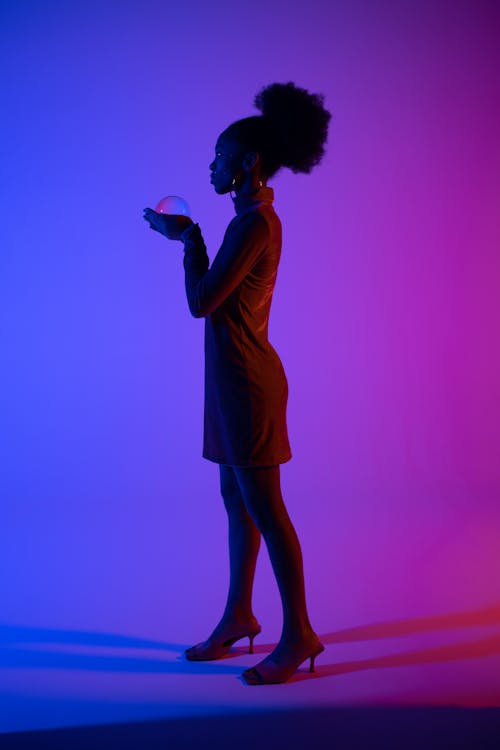Photo of a Woman with Afro Hair Wearing Heels
