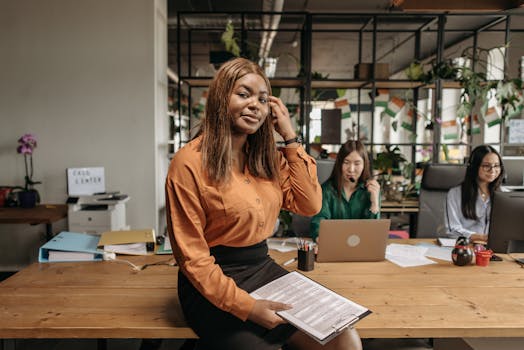 Businesswoman with clipboard in a vibrant, multicultural office environment.