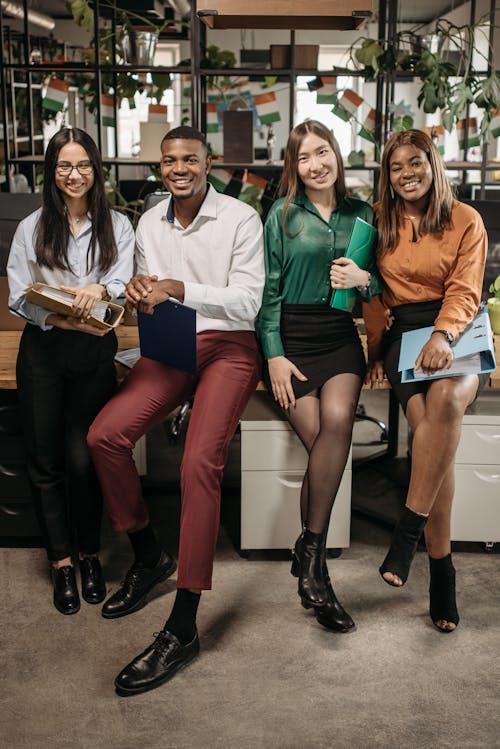 People Sitting on the table Holding Folders and Files