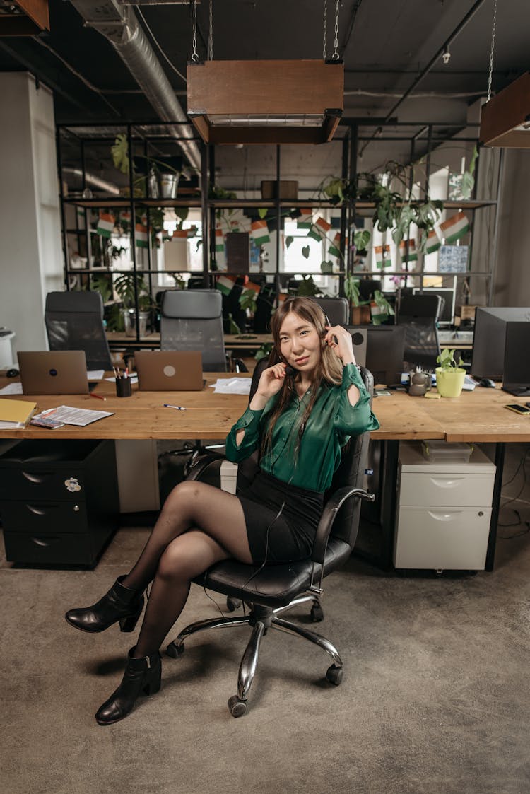 Woman In Green Long Sleeve Shirt Sitting On Office Chair