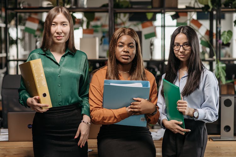 Women Holding Binders