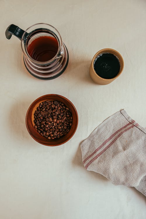 Free Bowl of Coffee Beans Near Table Napkin Stock Photo