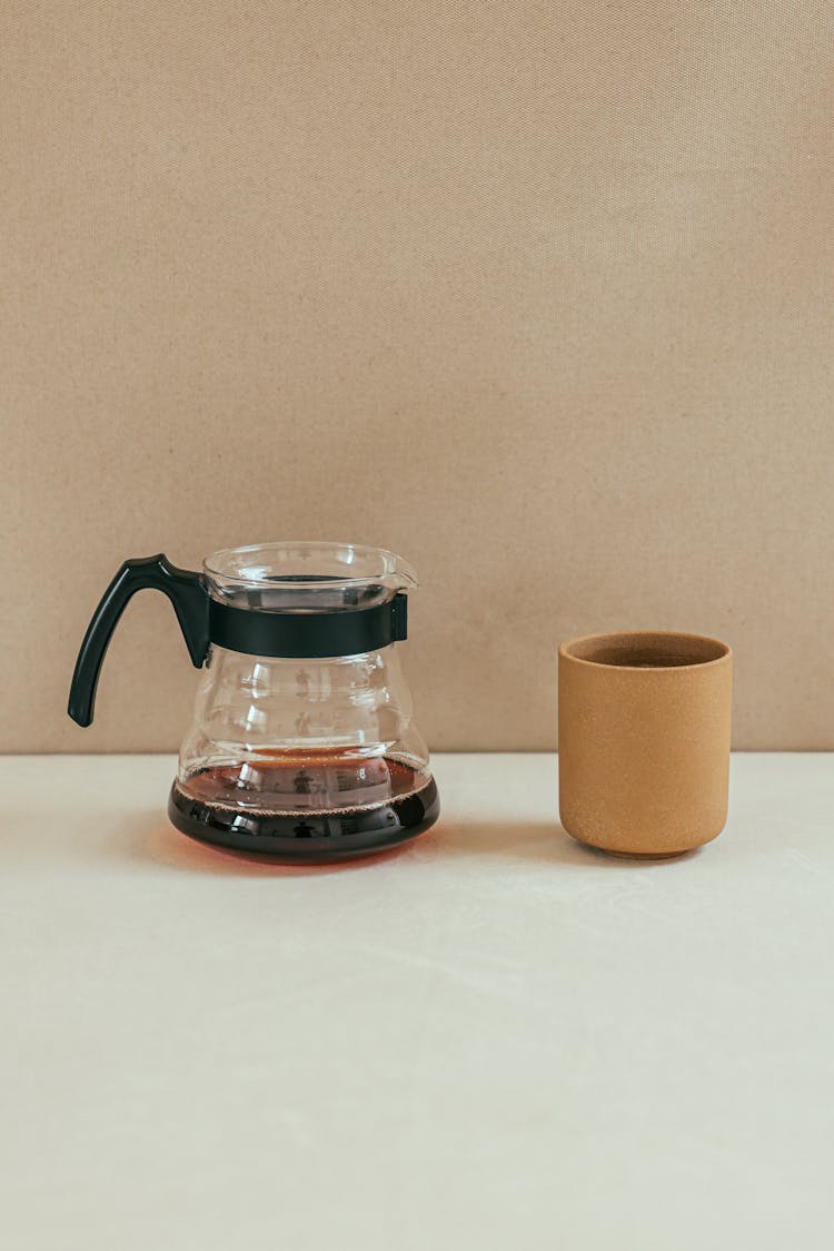 Clear Glass Coffee Pot Near Brown Ceramic Mug