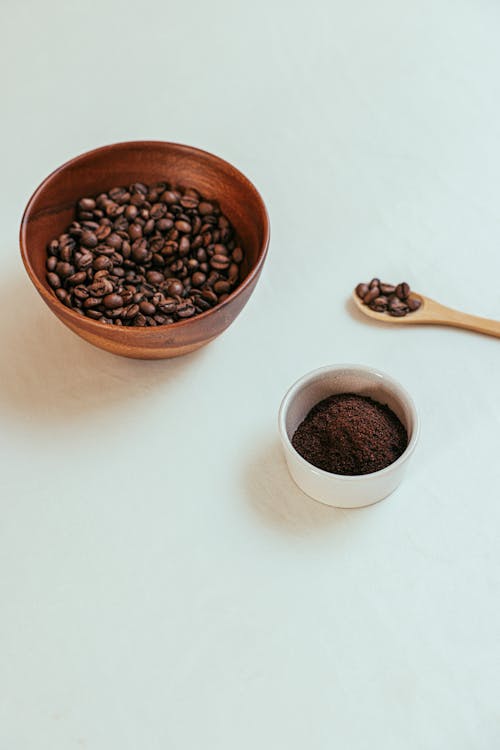 A Bowl of Coffee Beans and a Cup of Ground Coffee